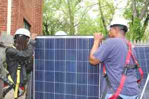 Workers check solar panels at a home in Northeast Washington, May 3, 2016. (Xiumei Dong/MNS) - See more at: http://dc.medill.northwestern.edu/blog/2016/05/10/turning-low-income-neighborhoods-on-to-solar-power/#sthash.pPZMk88y.dpuf